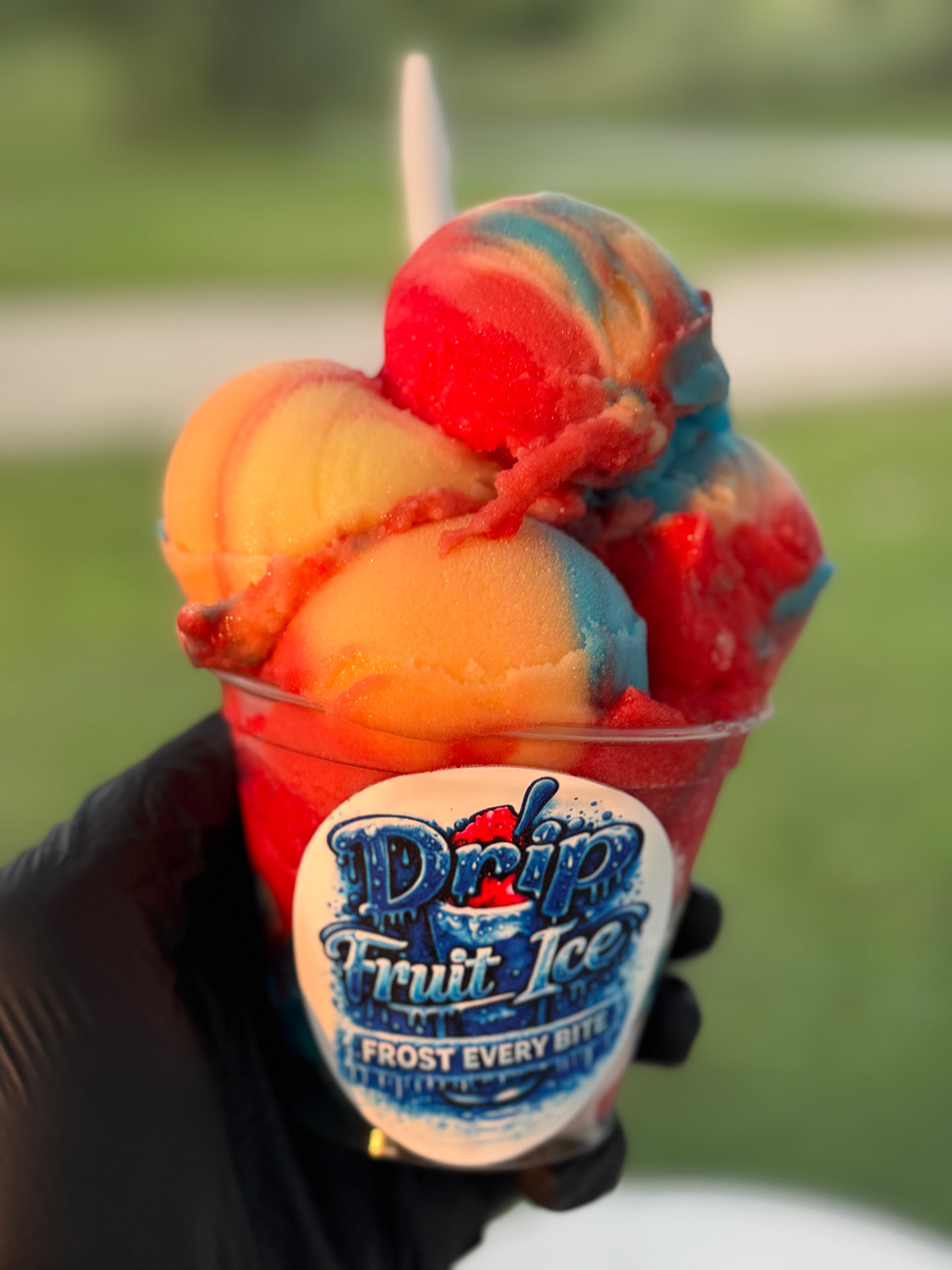 Colorful scoops of Drip Fruit Ice served in a cup